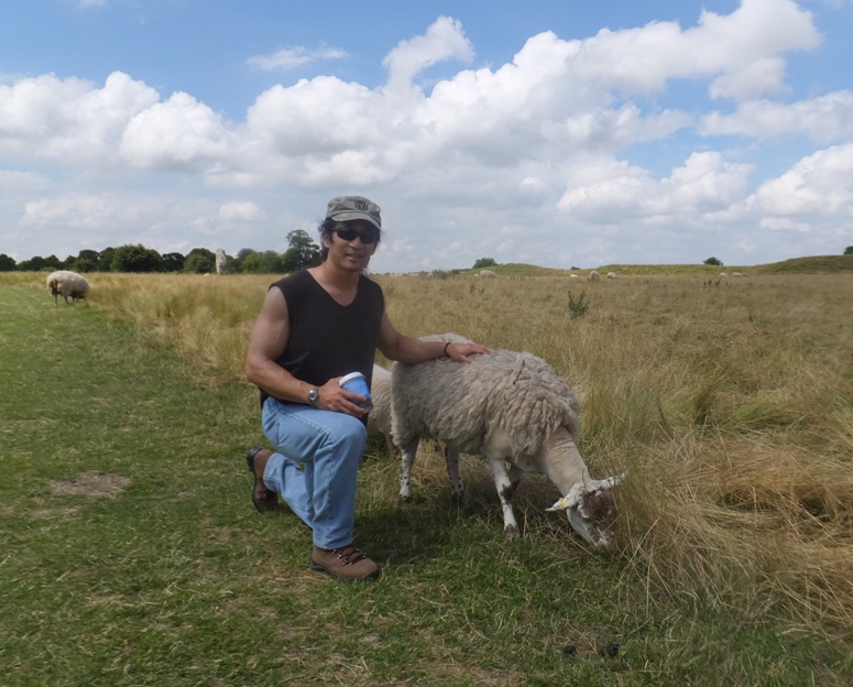 Me kneeling by a sheep
