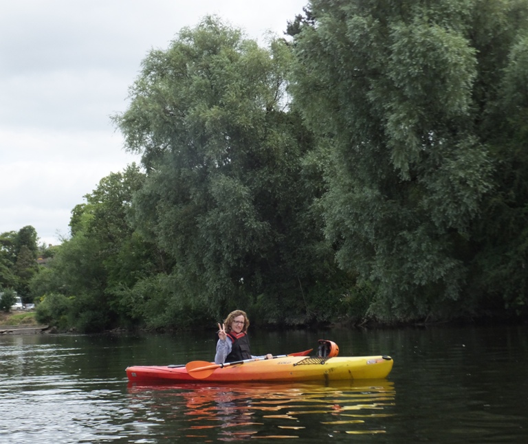 Norma in her kayak, flashing me the peace sign
