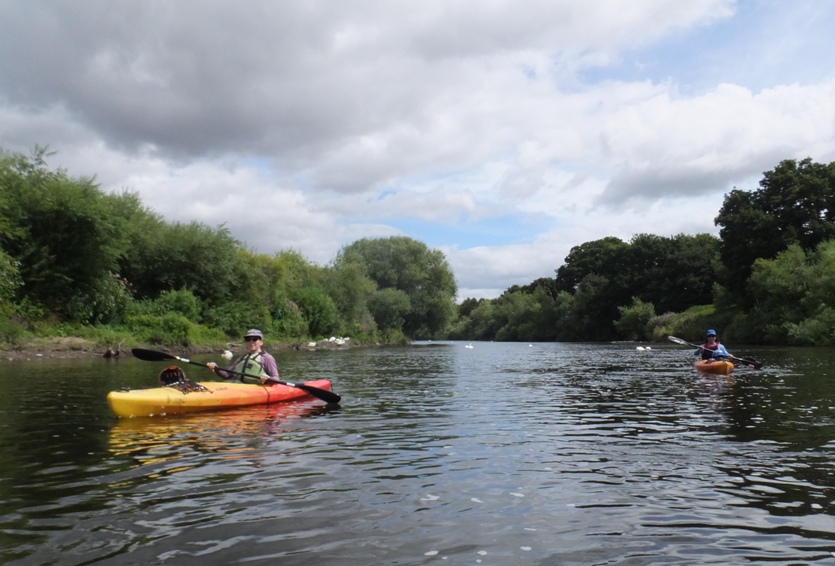 Sara and I kayaking with swans in the distance