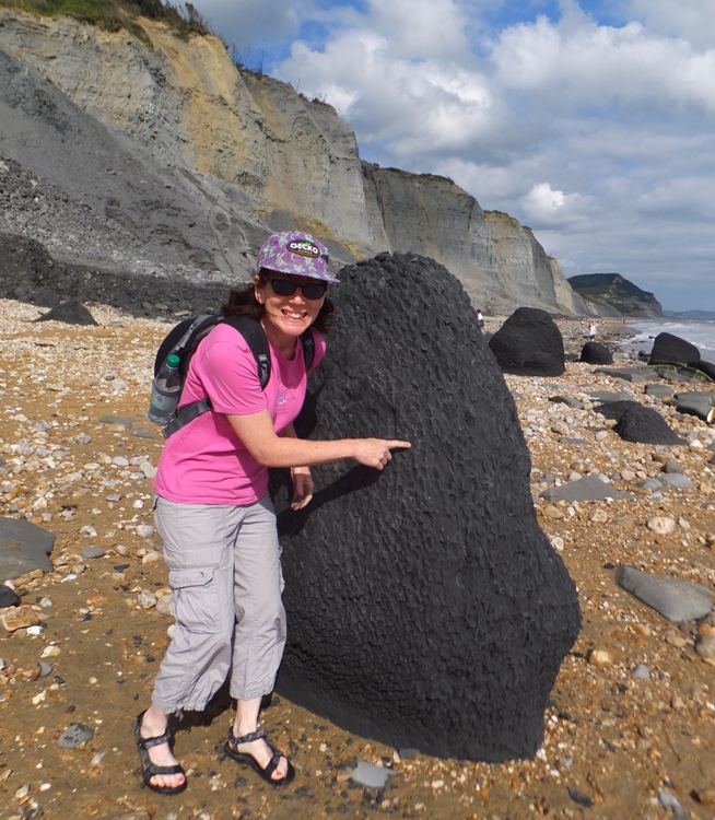 Sara pointing to a fossil