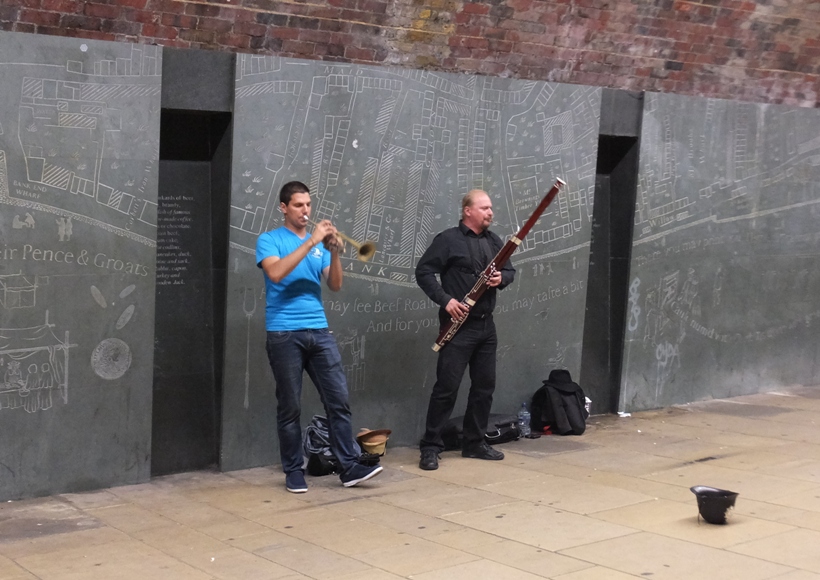 Two men playing the trumpet and bassoon