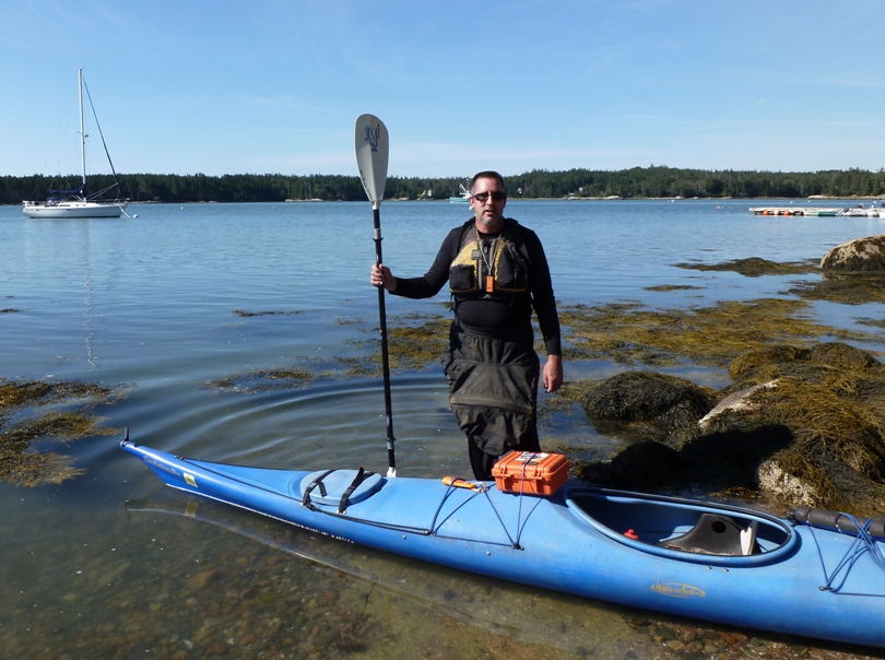 Vince standing by his kayak