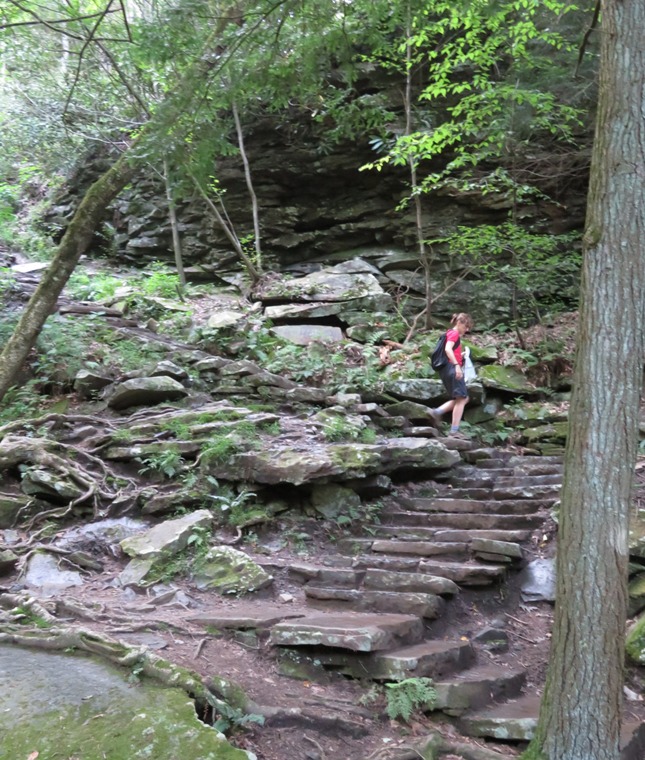 Norma walking down stone stairs