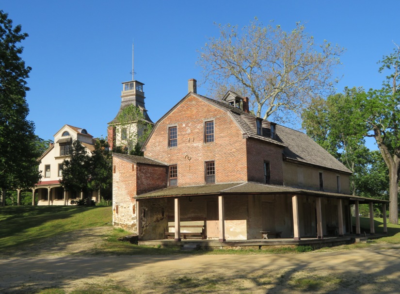 Brick building with mansion behind