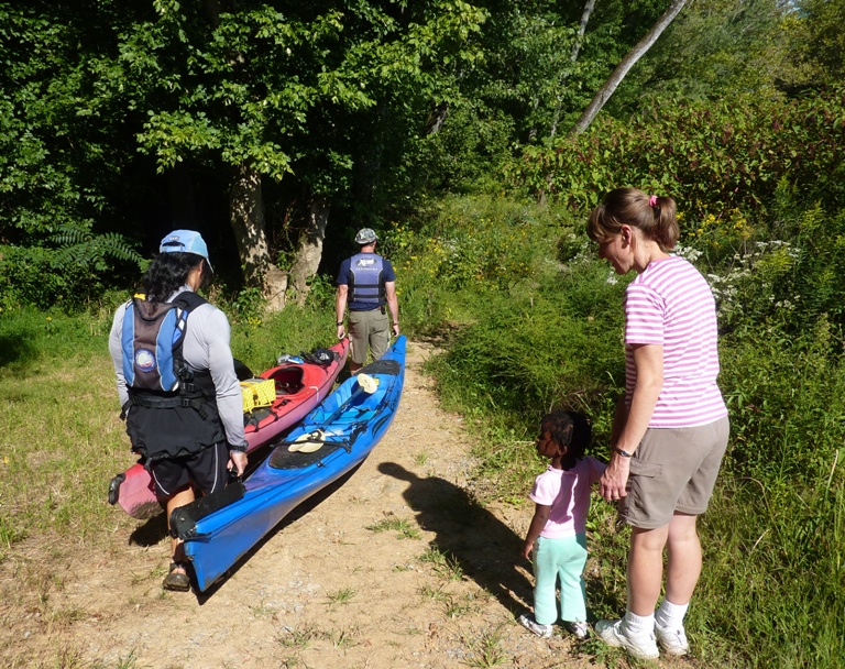 Jimmy and me carring the boats with Joyce and daughter watching