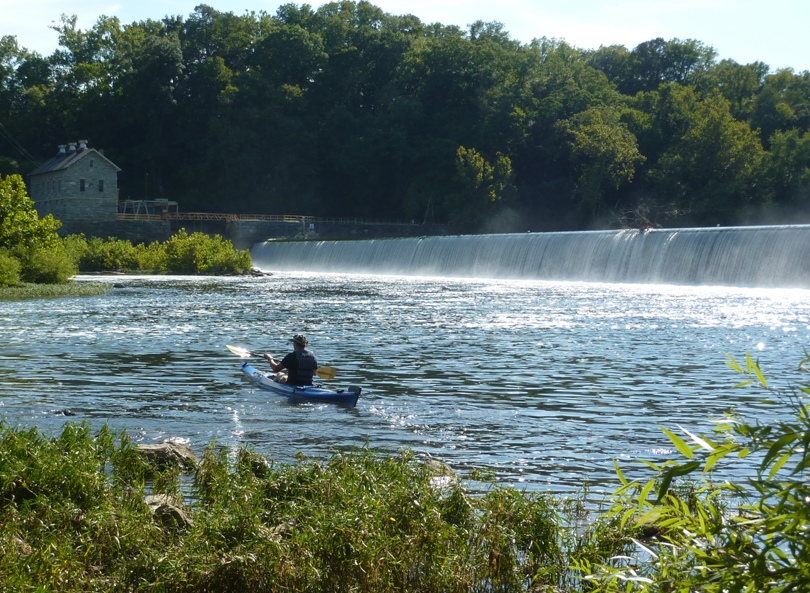 Jimmy in kayak with Dam 4 behind
