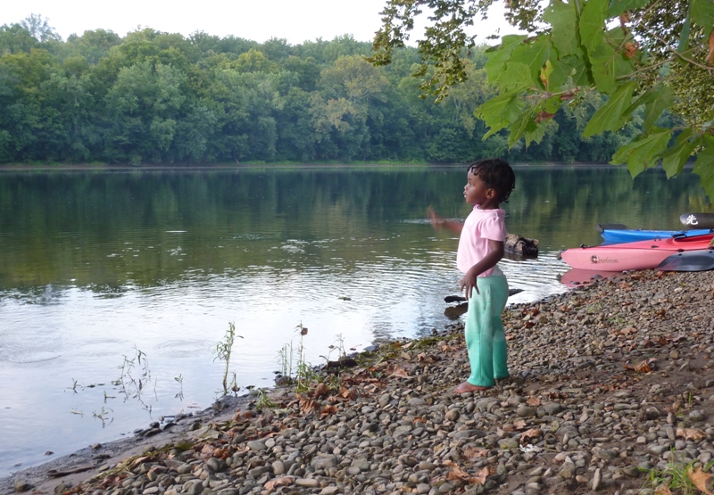 Little girl standing along the shore