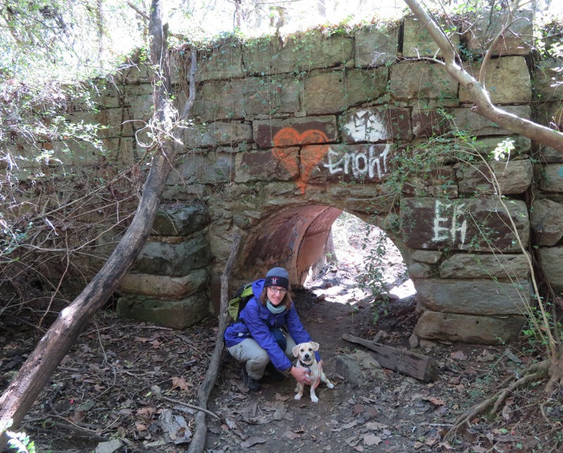 Norma and Daphne at big, old stone wall with small tunnel
