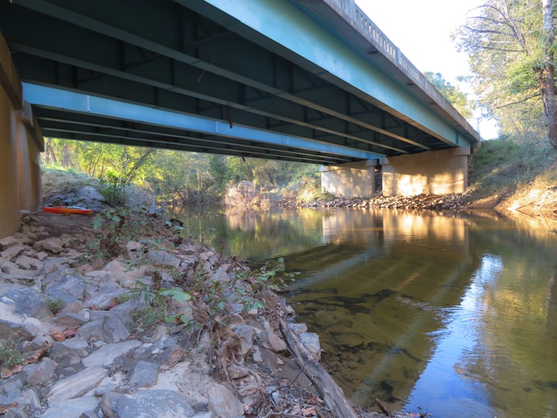 Narrow river view under a bridge