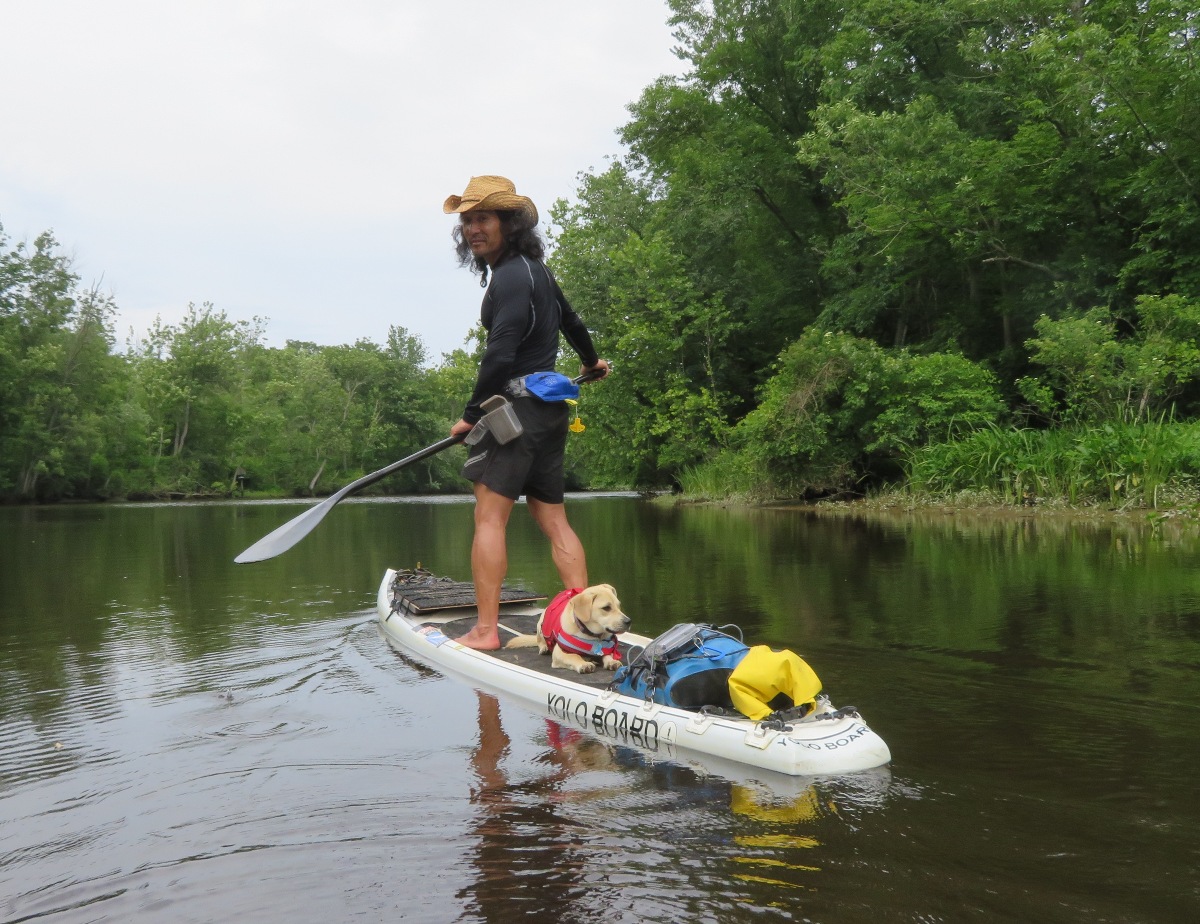 Me standing and Daphne lying down on SUP
