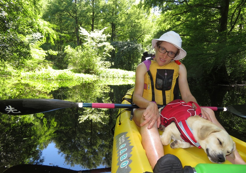 Norma and Daphne on kayak with Daphne asleep