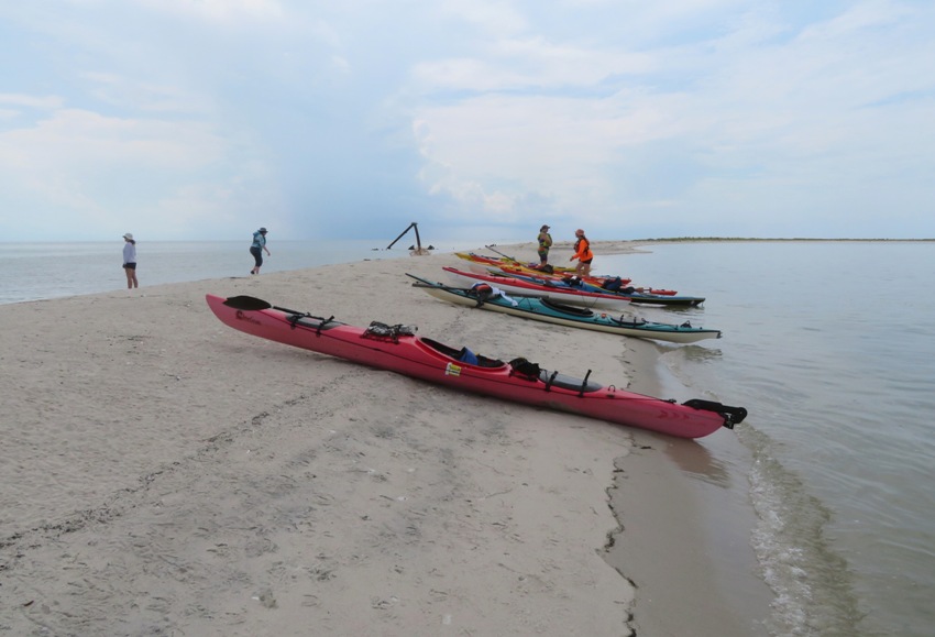 Kayaks and people on beach
