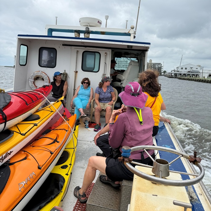 Kayaks and people on power boat, heading back to Crisfield