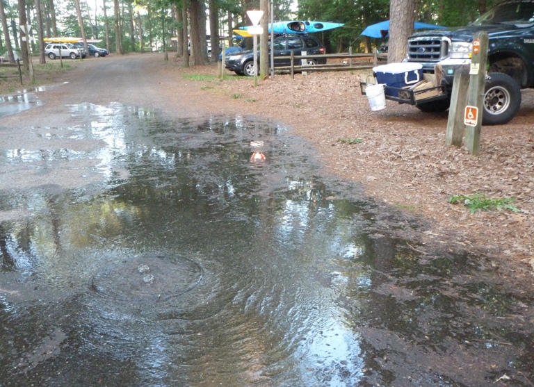 Lots of water leaking out manhole cover