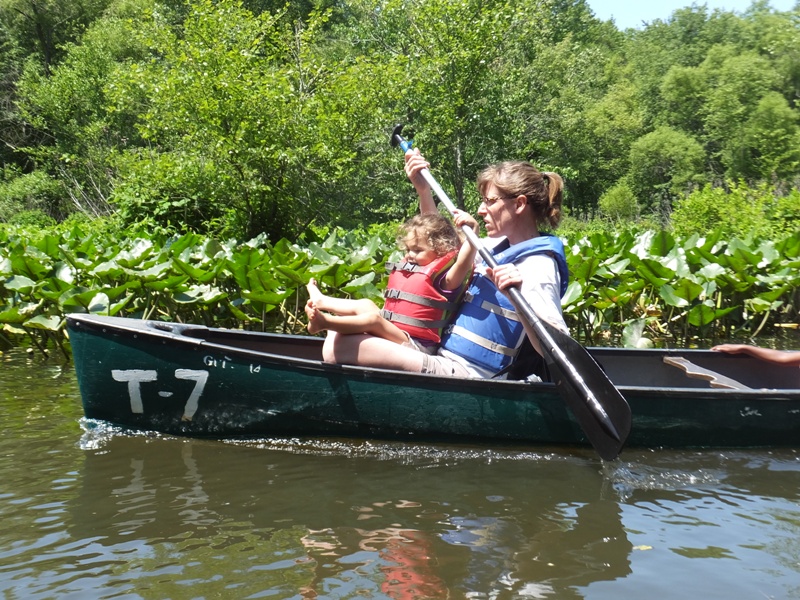 Joyce's daughter trying to hold onto paddle while Joyce paddles