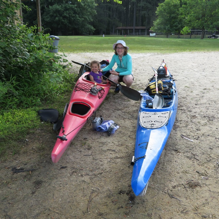 Norma and her niece with kayaks on the beach