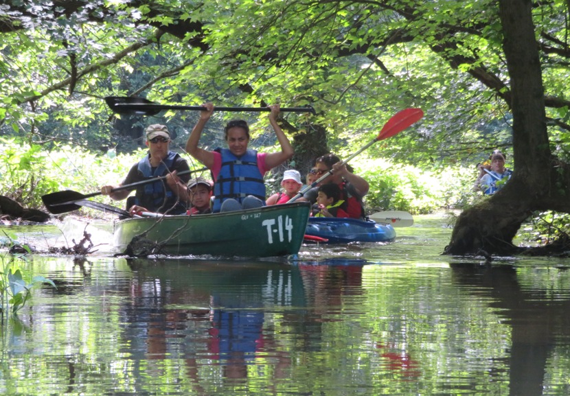 Harald and Rekha paddling on a shallow, shady section of the river