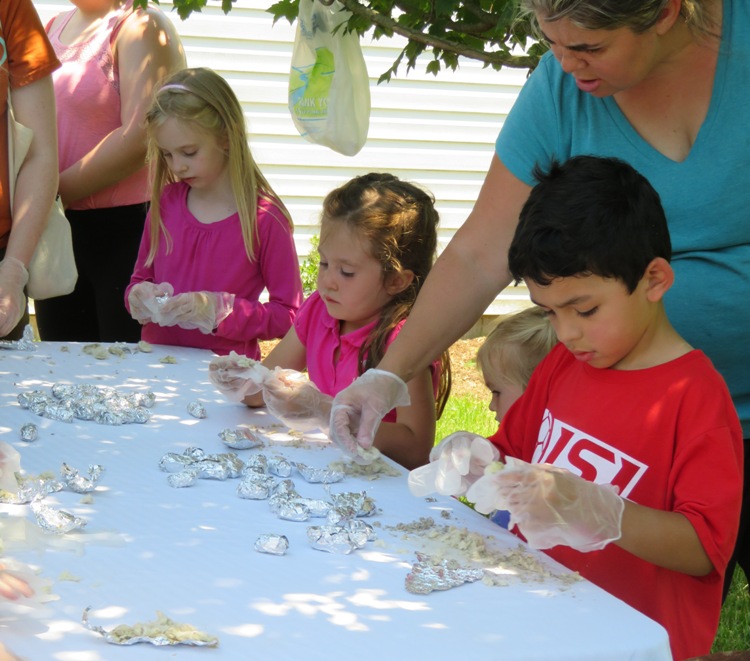 Three kids dissecting owl pellets