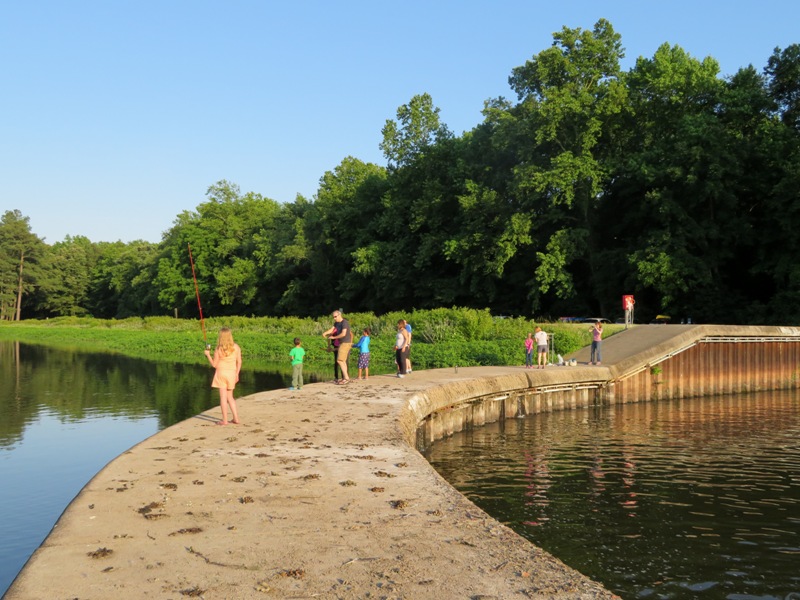 People standing on the dam, fishing