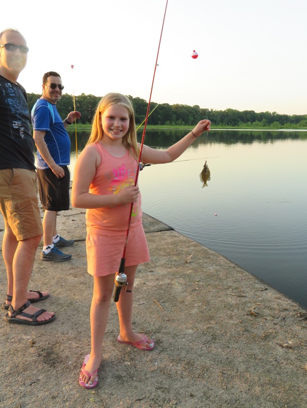 Stacy's granddaughter with a small blue gill at the end of her line