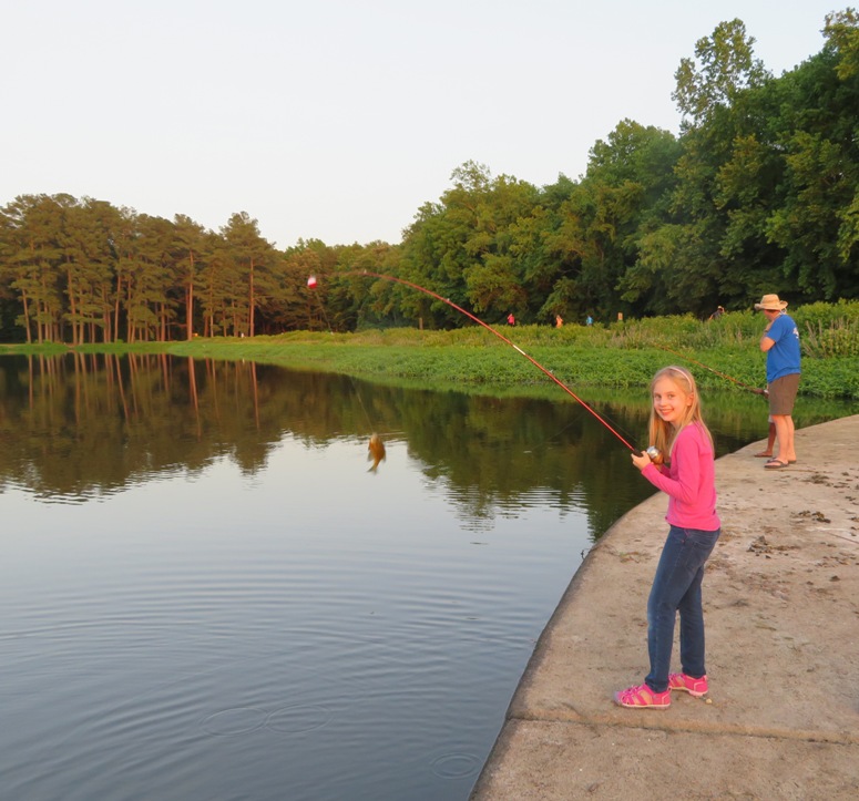 Mark and Allison's daughter with a fish