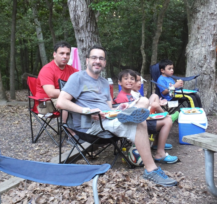 Rey, Federico, and their kids eating and sitting