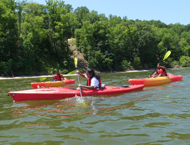 Malar's three girls in single kayaks