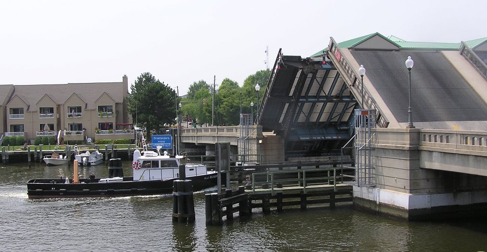 Boat passing under raised drawbridge
