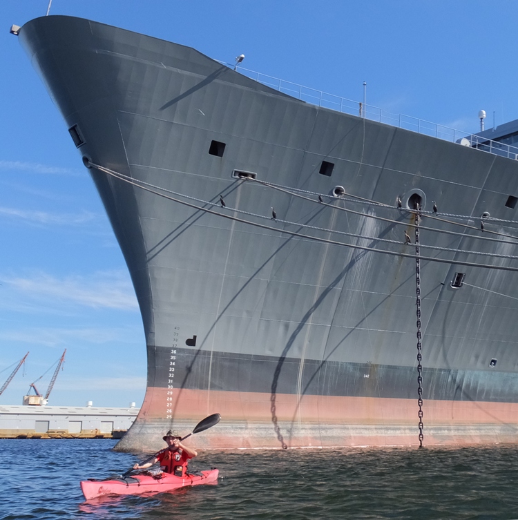 Alex kayaking near the bow of the ship