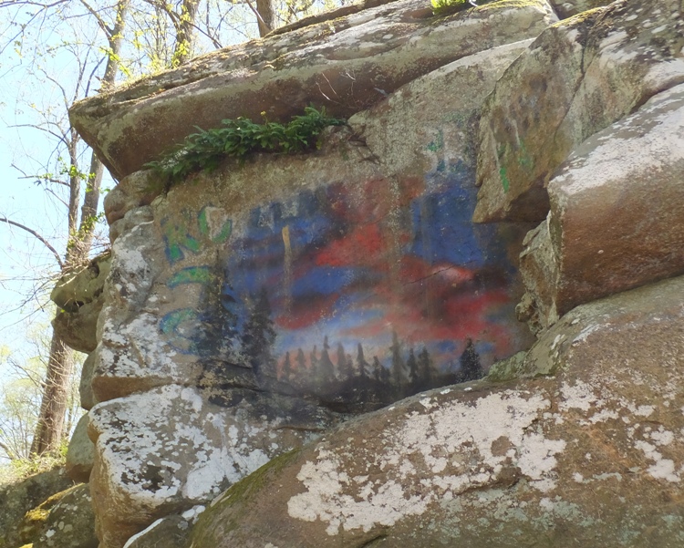 Sunset scene painted on rock at overlook