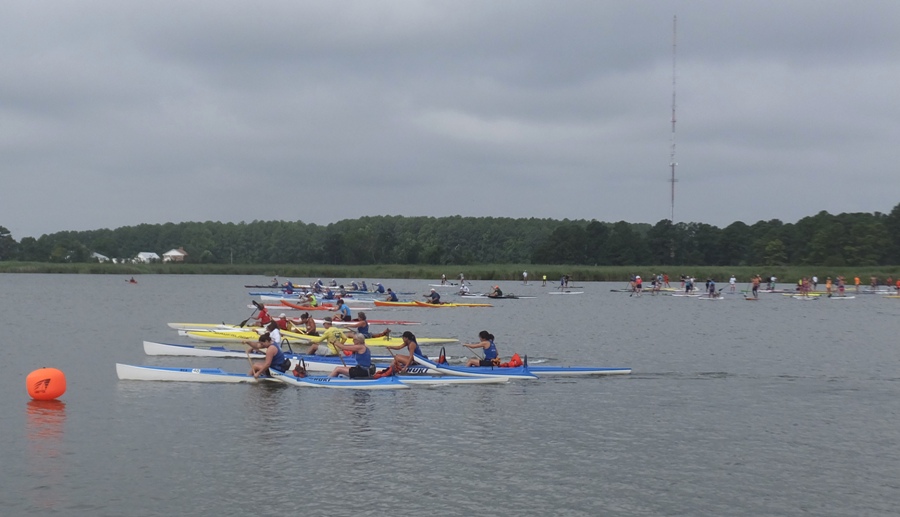 Canoes and surf skis crossing the start line