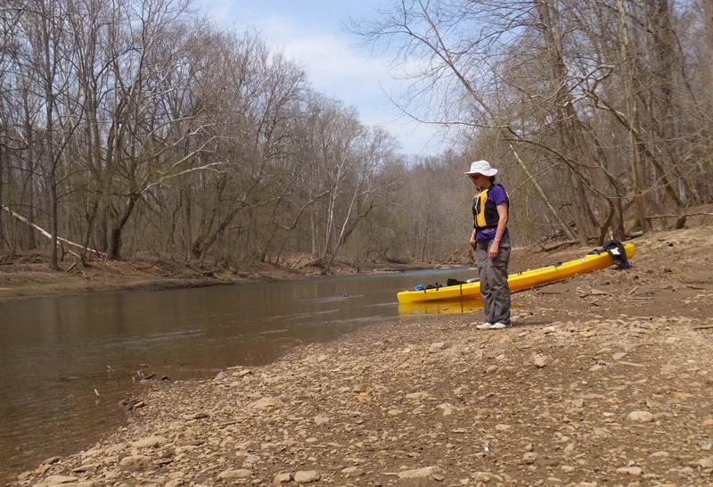 Norma pulled ashore with kayak, watching toads in the water