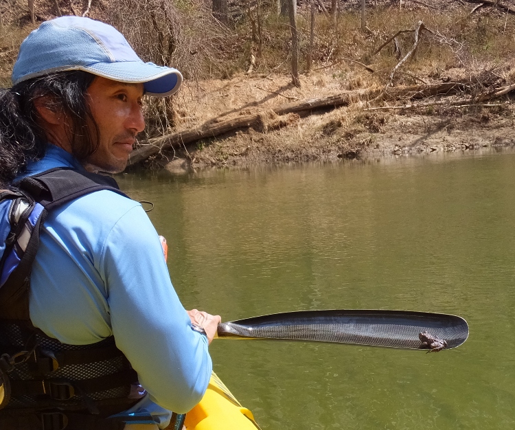Me holding my paddle with a toad perched at the end