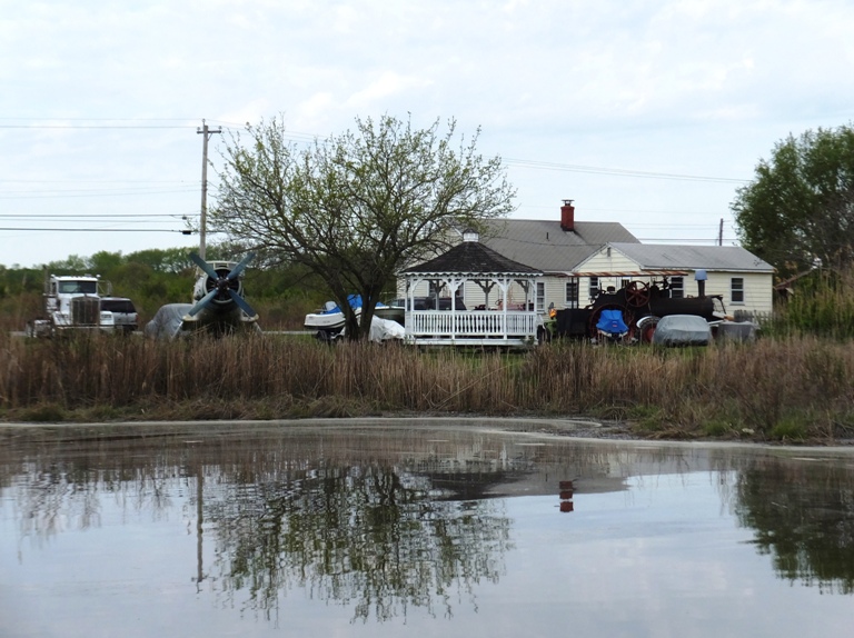Truck, plane, tree, gazebo, house, and cars