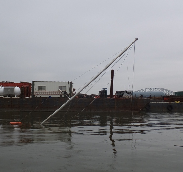 Crooked mast sticking out of the water