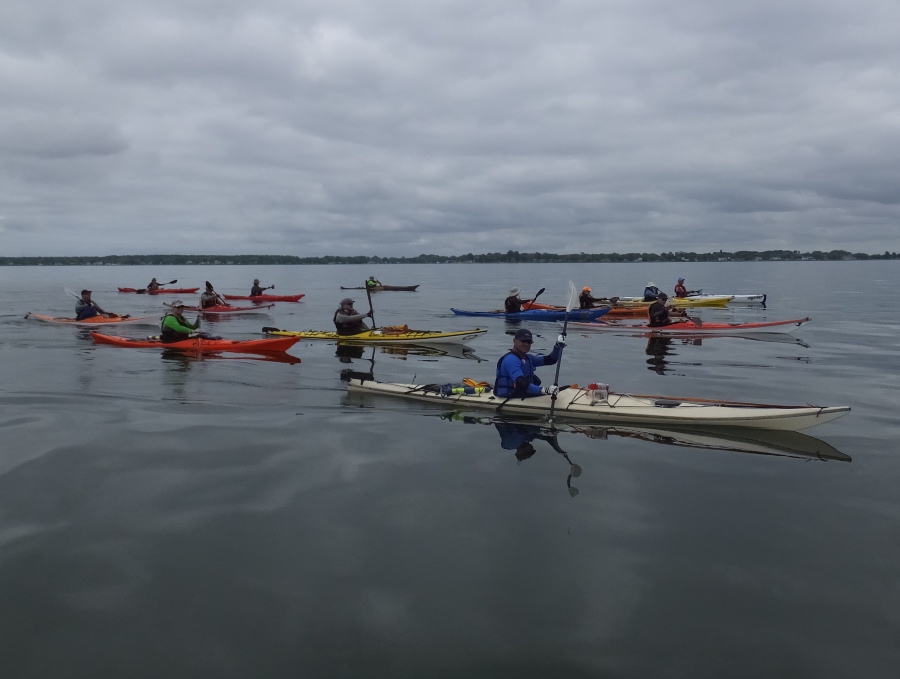 Kayakers paddling on smooth water