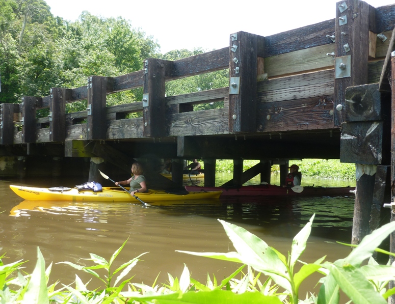 Stacy kayaking under Crouse Mill Road bridge