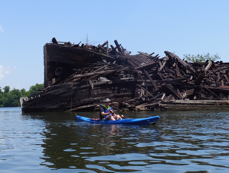 Jimmy kayaking in front of a wreck near Stahl Point