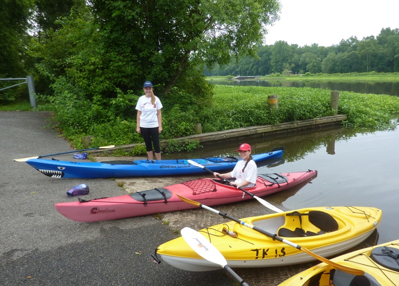 Katharina and Jana with kayaks launching at boat ramp
