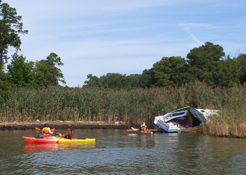 Kayakers investigating power boat wreck