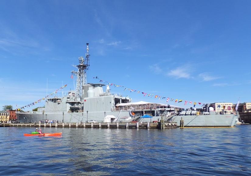 Two kayaks in front of the HMCS Athabaskan