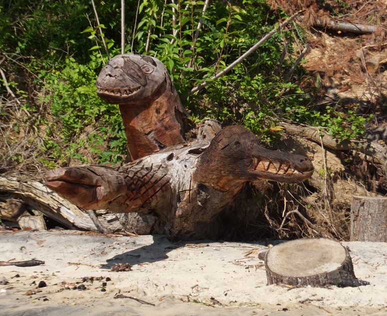 A three-headed monster carved into a log