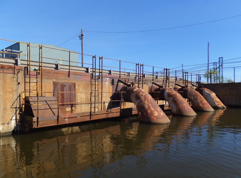 Steel and concrete wall with four big pipes