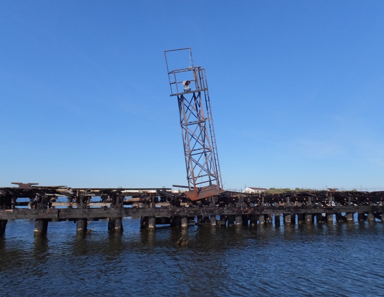 Leaning metal frame of what might have been an old light tower