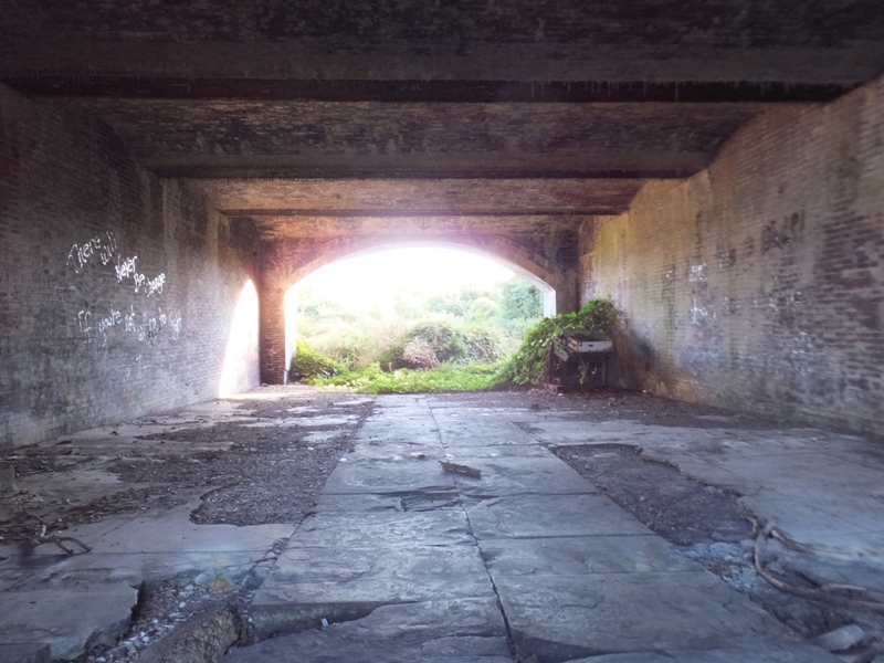 Stone floor and brick walls seen immediately upon entry