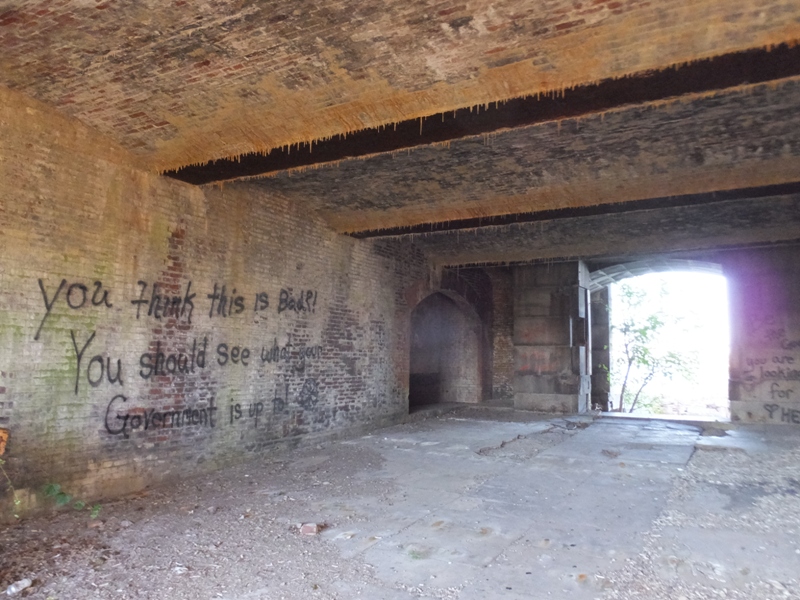 Graffiti on brick wall near entrance