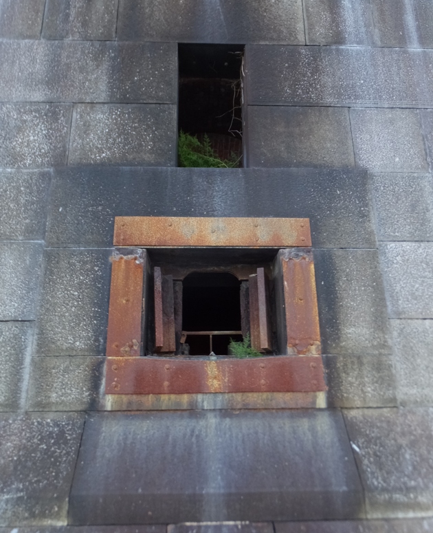 Steel shutters around opening in stone wall