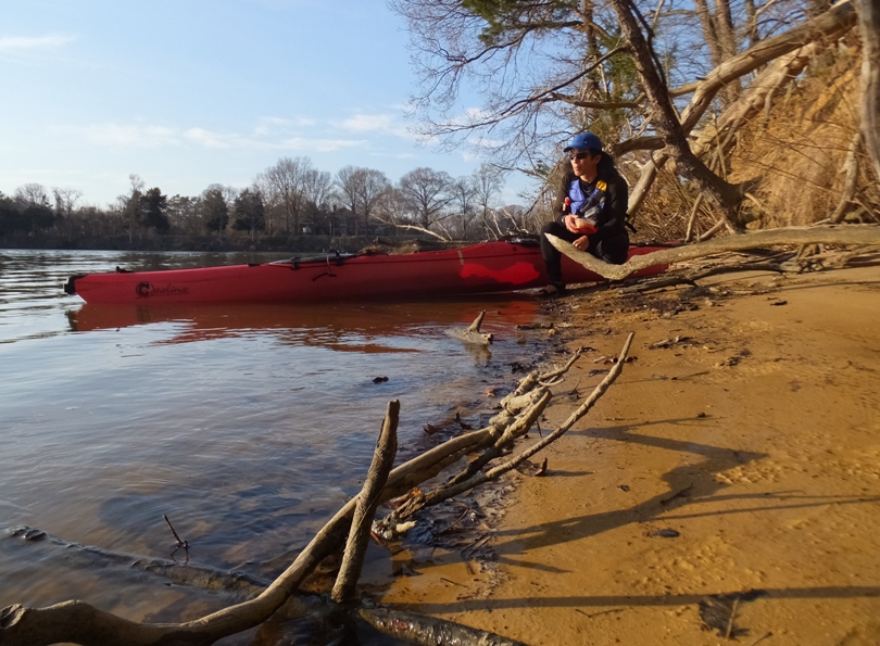 Me on shore next to my kayak