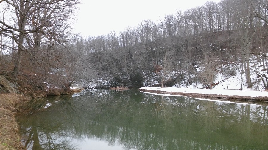Calm water with snow-covered shores