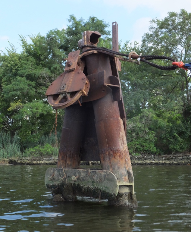 Tall metal thing with a cable and wheel on top